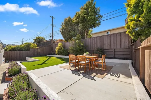 a view of a backyard with sitting area and furniture