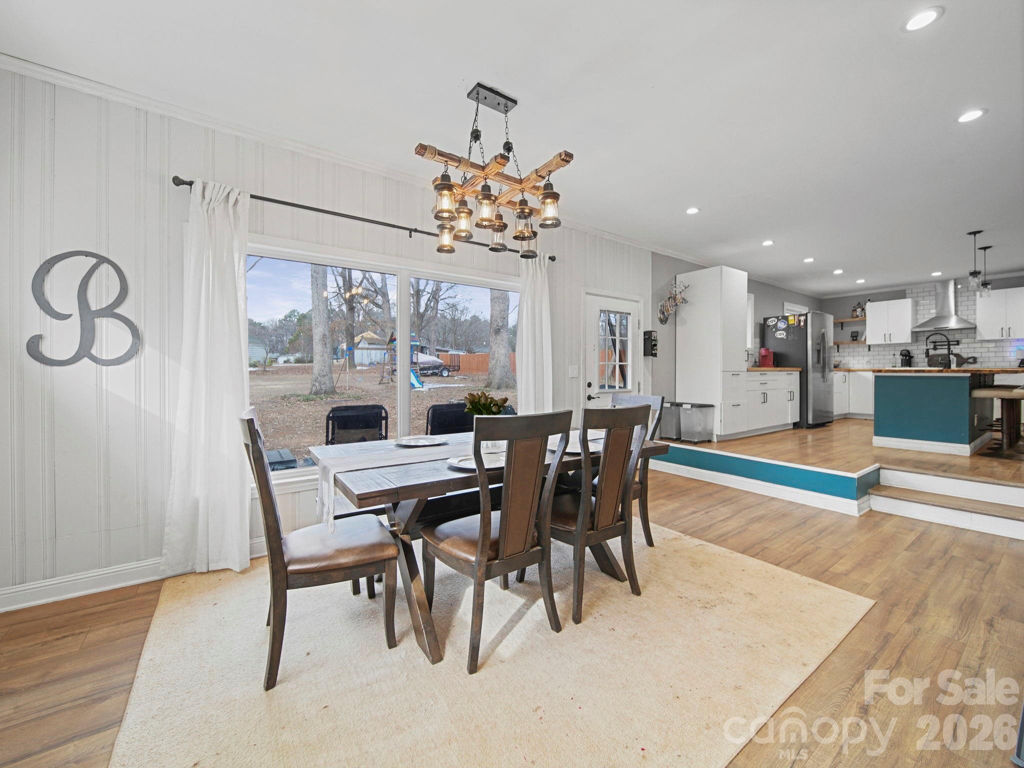 201 North Beverly Drive Locust, NC 28097 - Photo 14 of 36 a view of a dining room with furniture and wooden floor