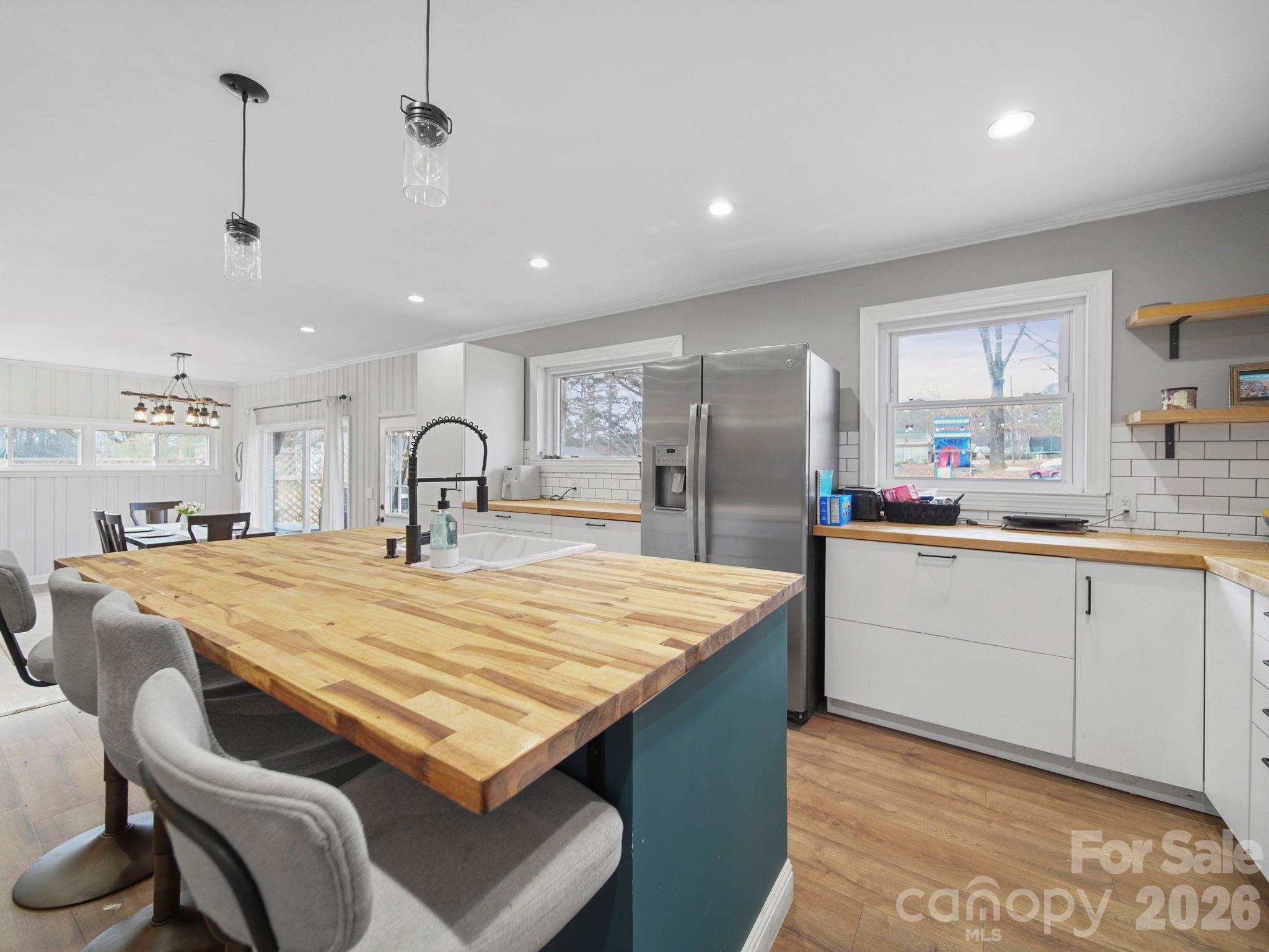 201 North Beverly Drive Locust, NC 28097 - Photo 17 of 36 a large kitchen with kitchen island a sink a stove a refrigerator and cabinets