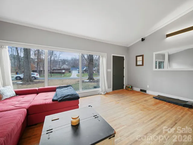 a bedroom with furniture and large windows