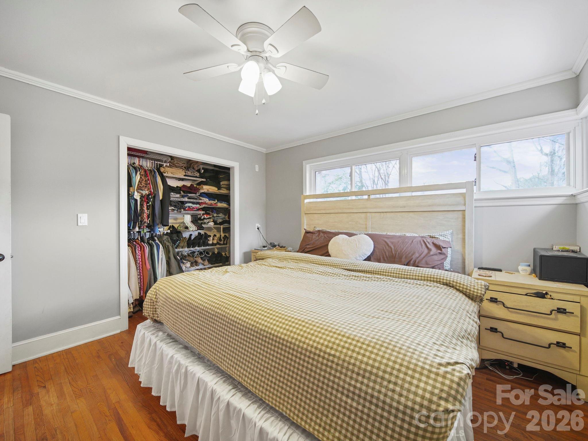 201 North Beverly Drive Locust, NC 28097 - Photo 26 of 36 a bedroom with a bed and a chandelier