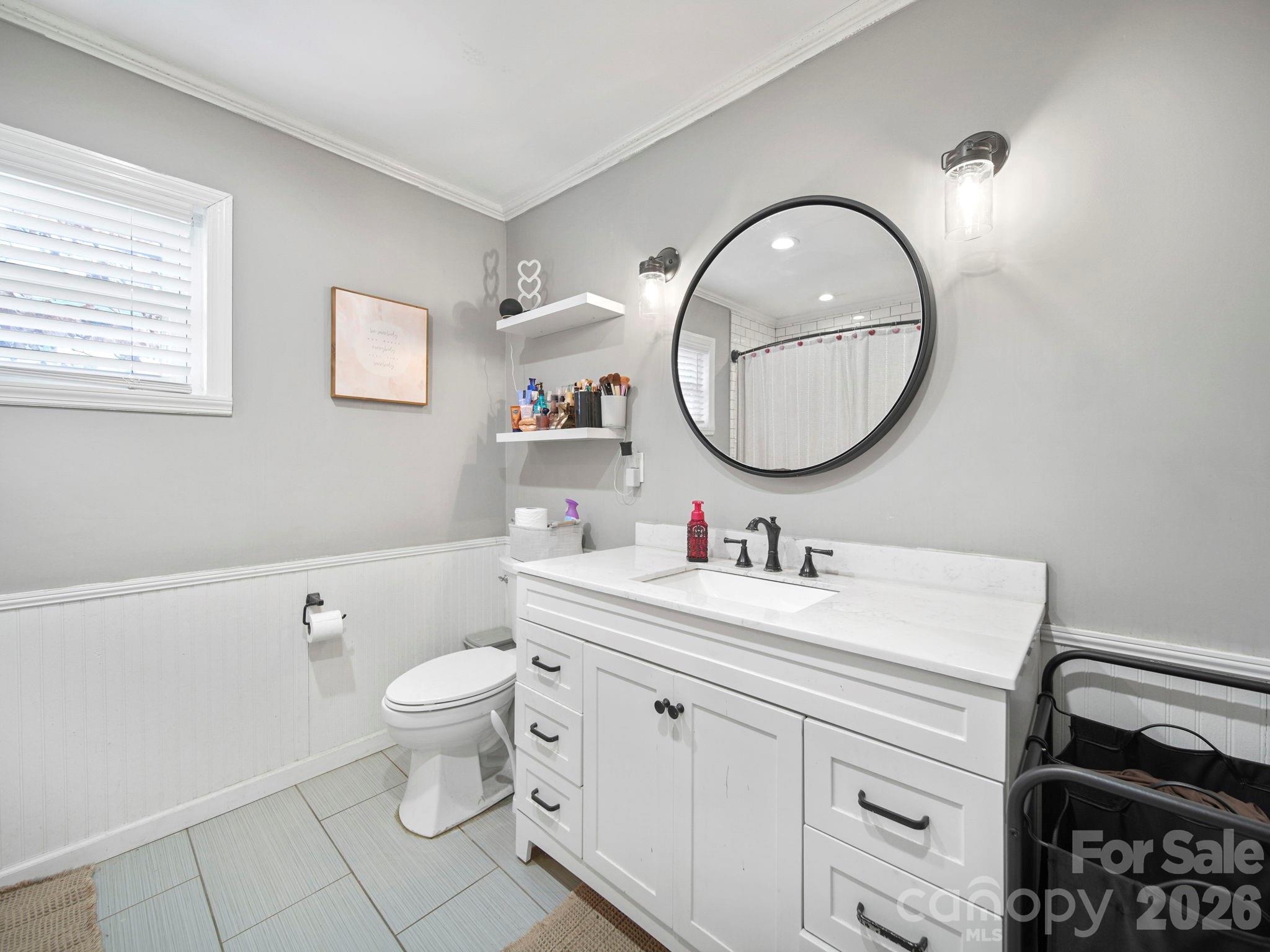 201 North Beverly Drive Locust, NC 28097 - Photo 27 of 36 a bathroom with a toilet a sink and mirror