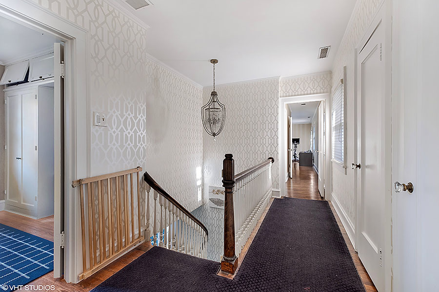 480 Sheridan Road Winnetka, IL 60093 - Photo 14 of 29 a view of a hallway with a white door and stairs