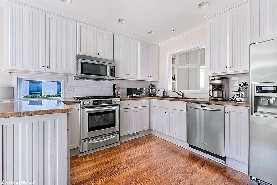 480 Sheridan Road Winnetka, IL 60093 - Photo 7 of 29 a kitchen with granite countertop white cabinets and appliances