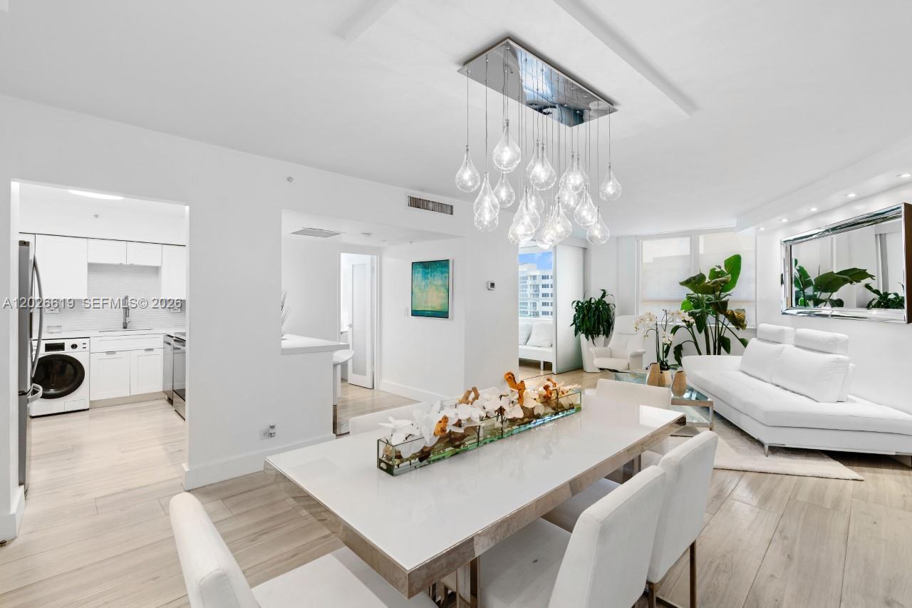 1500 Bay Road, Unit 1268S Miami Beach, FL 33139 - Photo 10 of 31 a view of a dining room with furniture and a chandelier