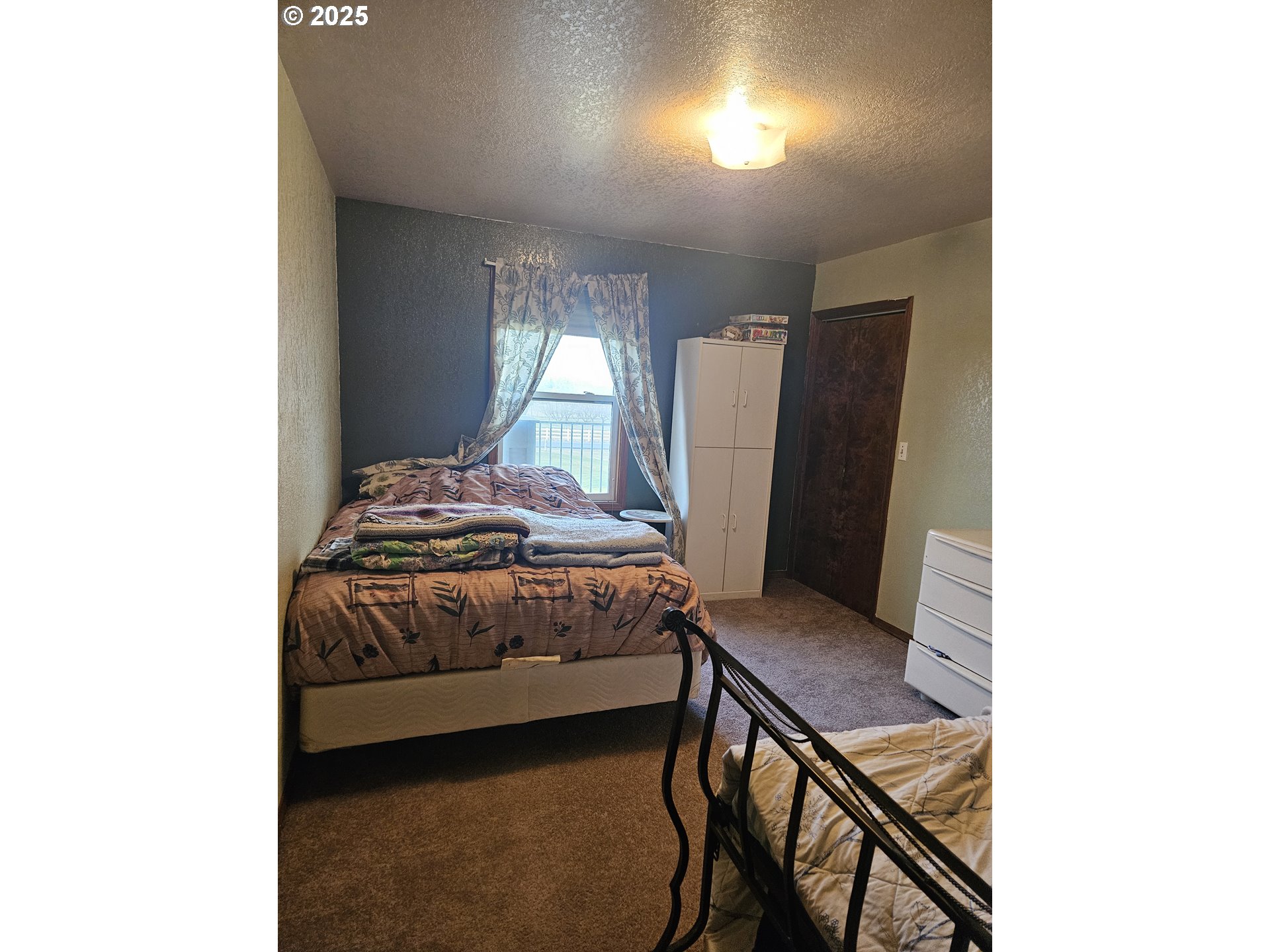 78845 Eastregaard Road Boardman, OR 97818 - Photo 13 of 27 a bedroom with a bed and a window