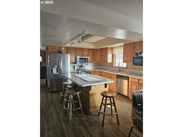 a kitchen with a sink cabinets and window