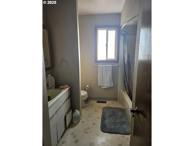 a bathroom with a toilet sink and a mirror