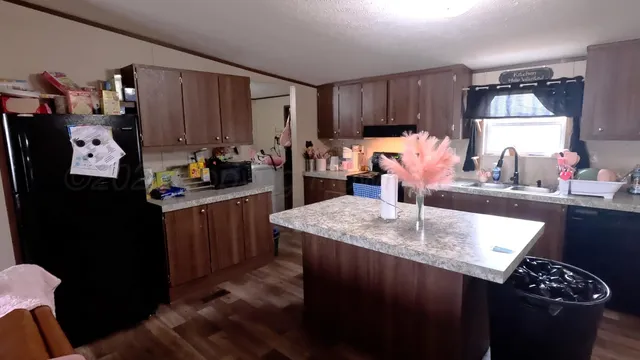 a kitchen with sink and refrigerator
