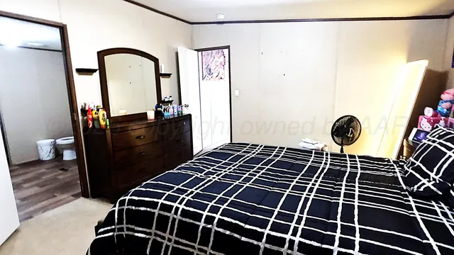 a bathroom with a granite countertop sink a toilet and a mirror