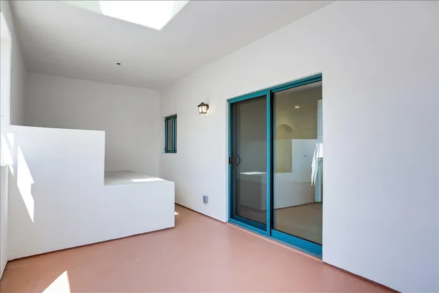 a living room with a sink and a refrigerator