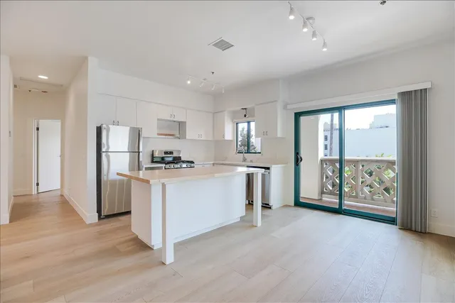 a kitchen with refrigerator and cabinets
