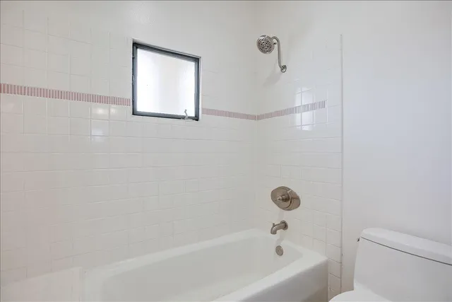 a bathroom with a bathtub and a toilet