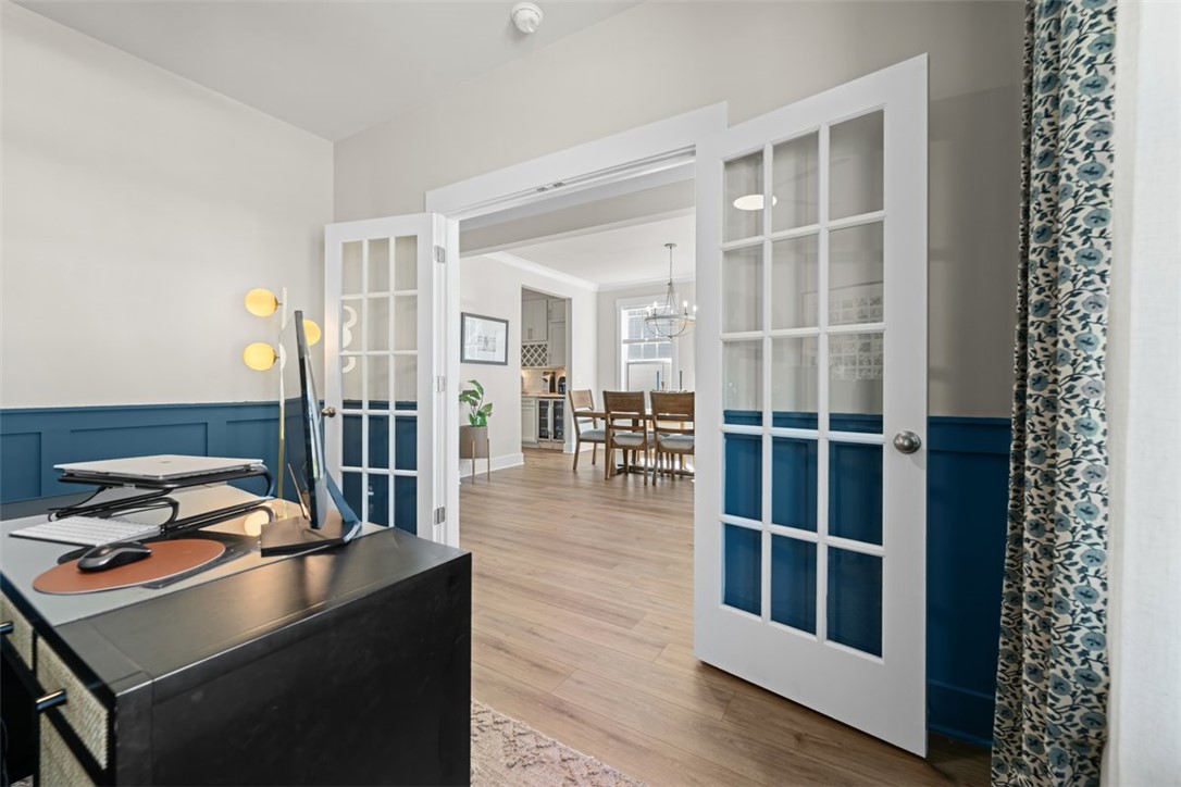 621 Wh Kay Lane Anderson, SC 29621 - Photo 5 of 50 French doors open into a bright study, offering views of the adjoining dining space with warm wood flooring.