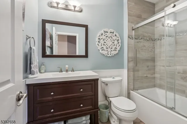 a bathroom with a toilet a sink and mirror