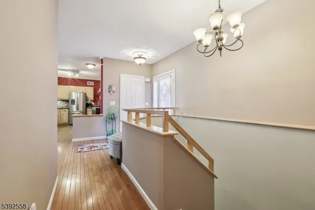 a view of a room with wooden floor and staircase