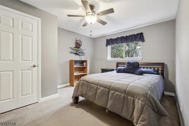 a bedroom with a bed a window and a chandelier