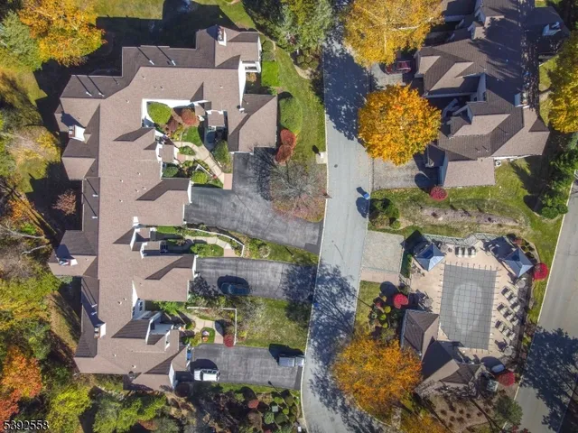an aerial view of a residential houses with outdoor space and swimming pool