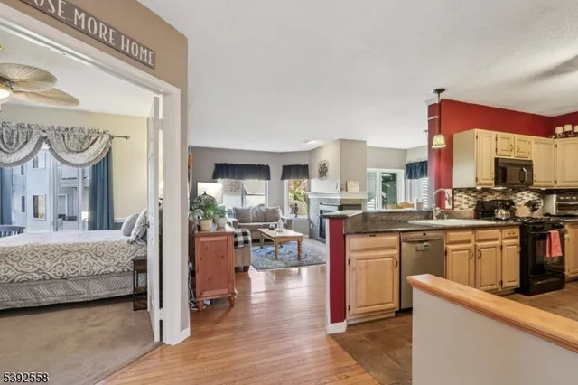 a kitchen with cabinets and wooden floor