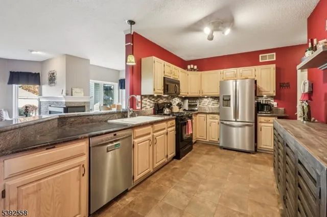 a kitchen with stainless steel appliances a refrigerator sink and cabinets