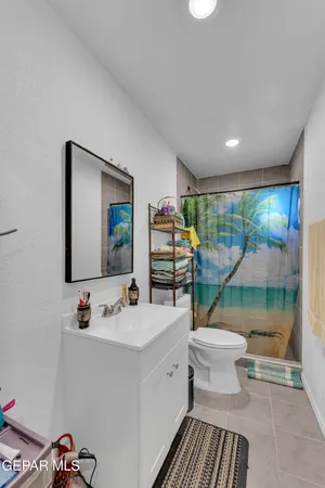 a bathroom with a sink mirror vanity and toilet