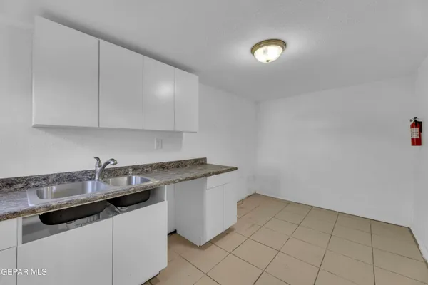 a kitchen with a sink and cabinets