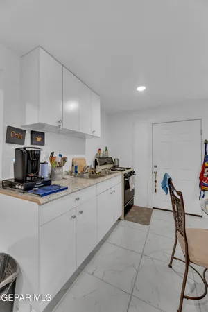 a kitchen with a sink a stove and cabinets