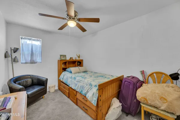 a bedroom with a bed and window