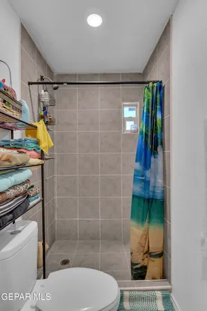 a bathroom with a toilet and a shower