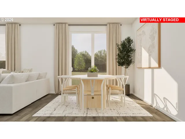 a dining room with furniture and a window