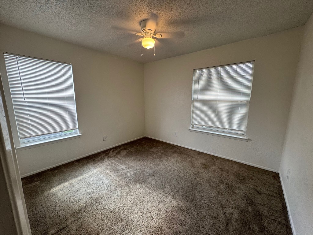 4810 West Wind Trail, Unit 103 Austin, TX 78745 - Photo 13 of 23 an empty room with windows and fan