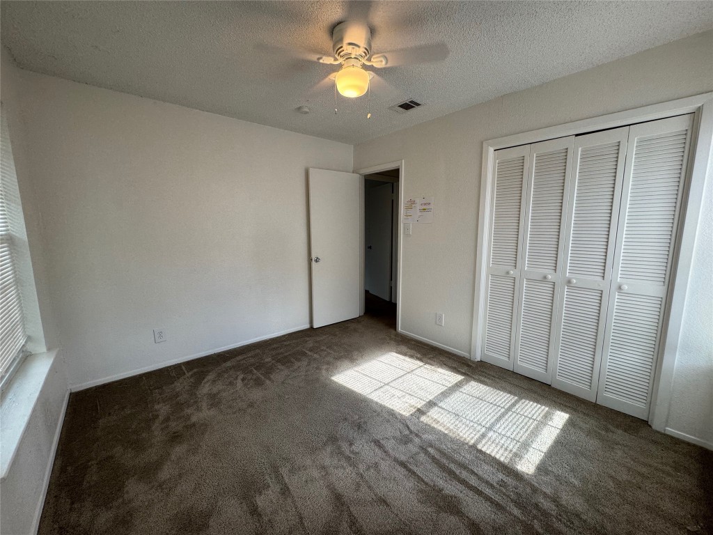 4810 West Wind Trail, Unit 103 Austin, TX 78745 - Photo 14 of 23 an empty room with windows and fan