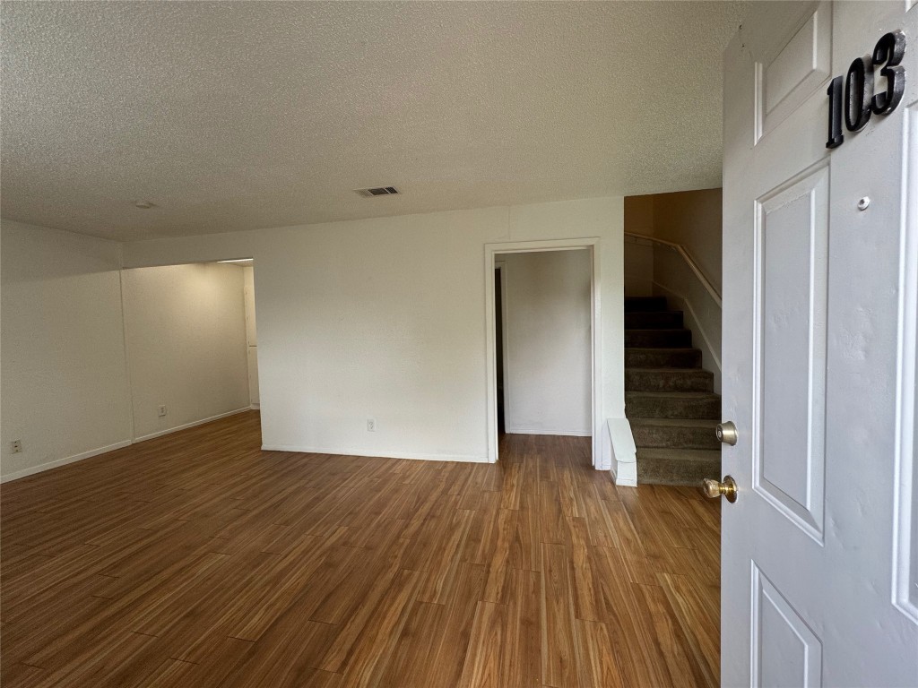 4810 West Wind Trail, Unit 103 Austin, TX 78745 - Photo 2 of 23 wooden floor in an empty room