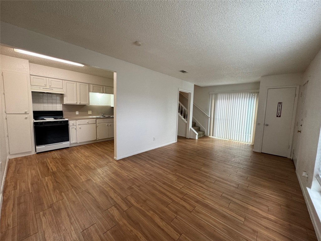 4810 West Wind Trail, Unit 103 Austin, TX 78745 - Photo 3 of 23 a view of a kitchen with a sink and a stove top oven