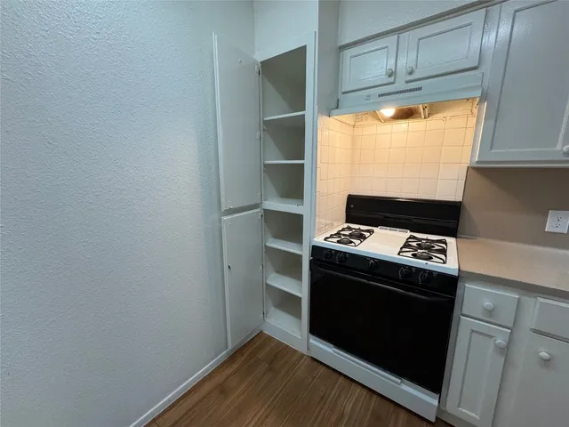 a stove top oven sitting inside of a kitchen