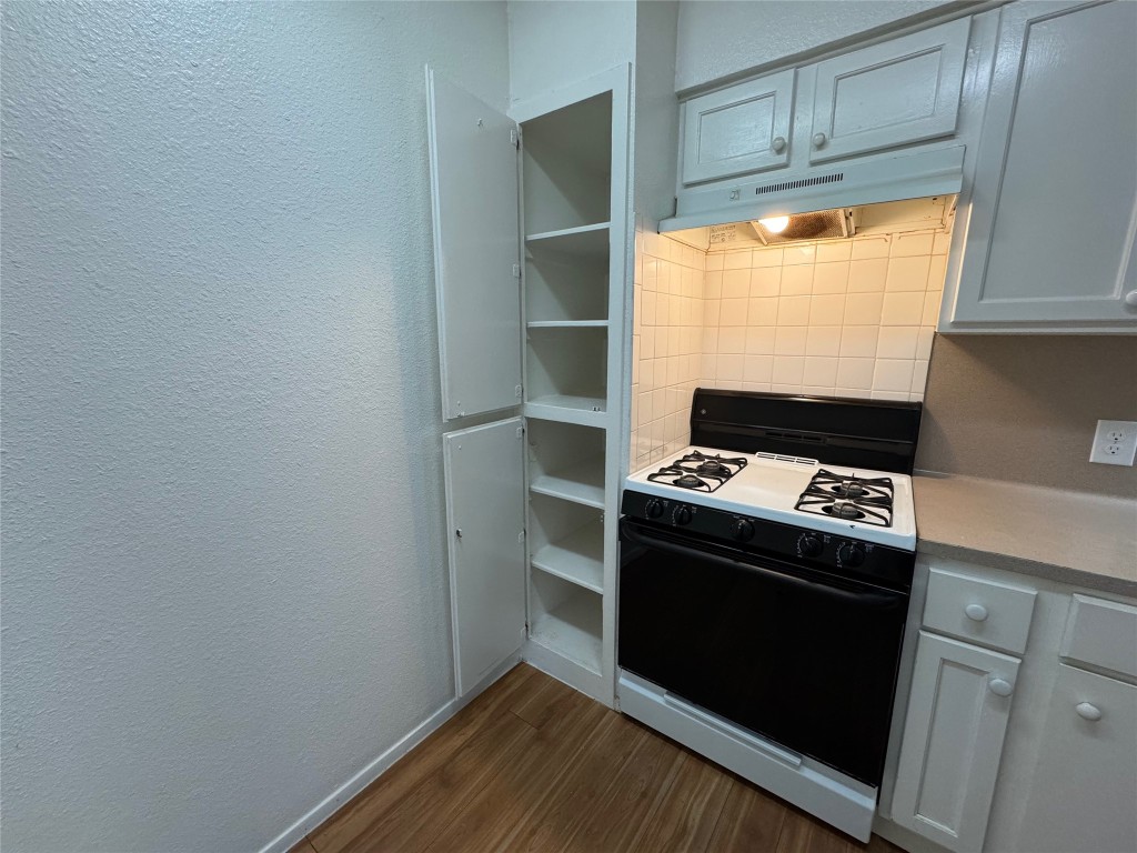 4810 West Wind Trail, Unit 103 Austin, TX 78745 - Photo 7 of 23 a stove top oven sitting inside of a kitchen
