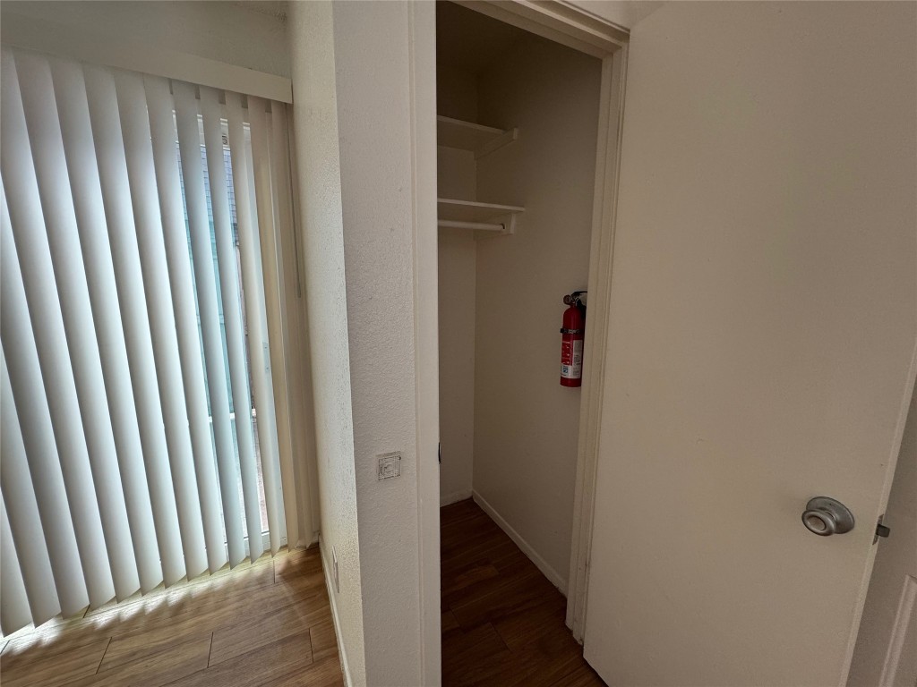 4810 West Wind Trail, Unit 103 Austin, TX 78745 - Photo 8 of 23 a view of a hallway with wooden floor