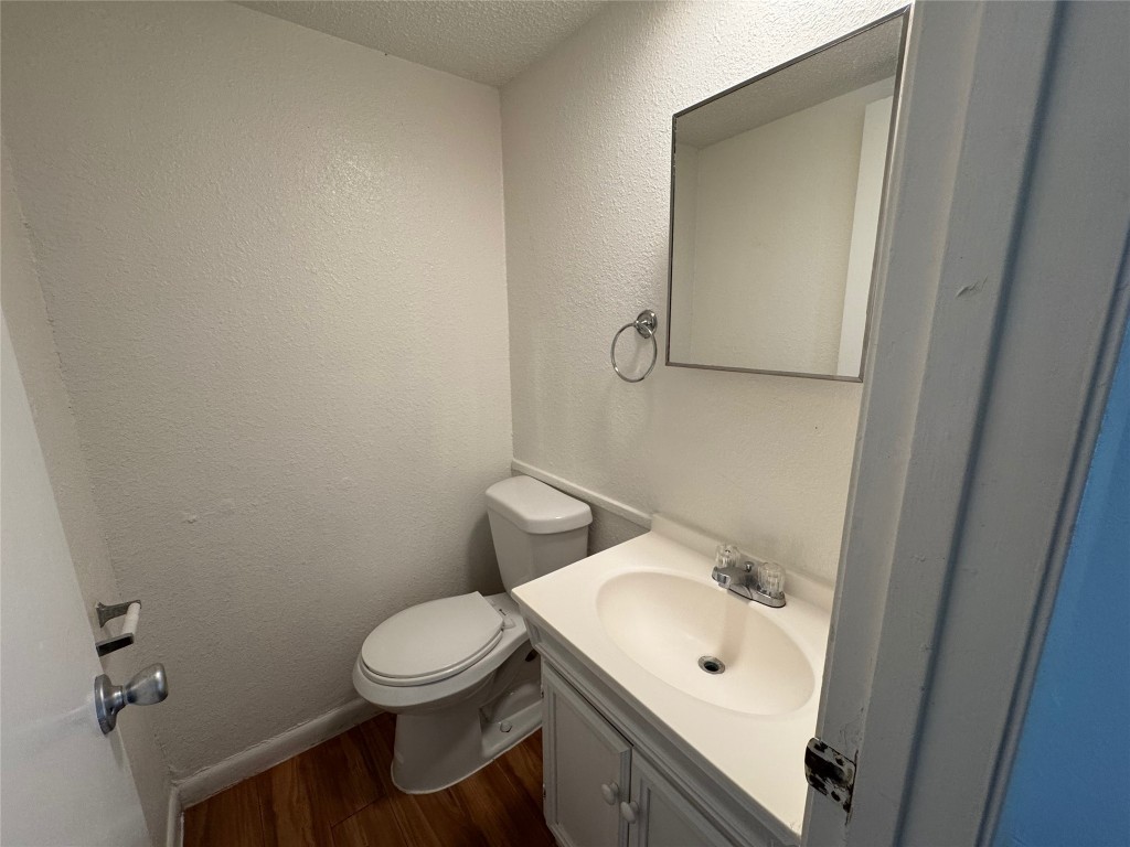 4810 West Wind Trail, Unit 103 Austin, TX 78745 - Photo 9 of 23 a bathroom with a toilet sink and mirror