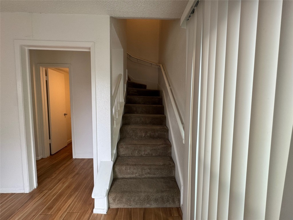 4810 West Wind Trail, Unit 103 Austin, TX 78745 - Photo 10 of 23 a view of a hallway with wooden floor and entryway
