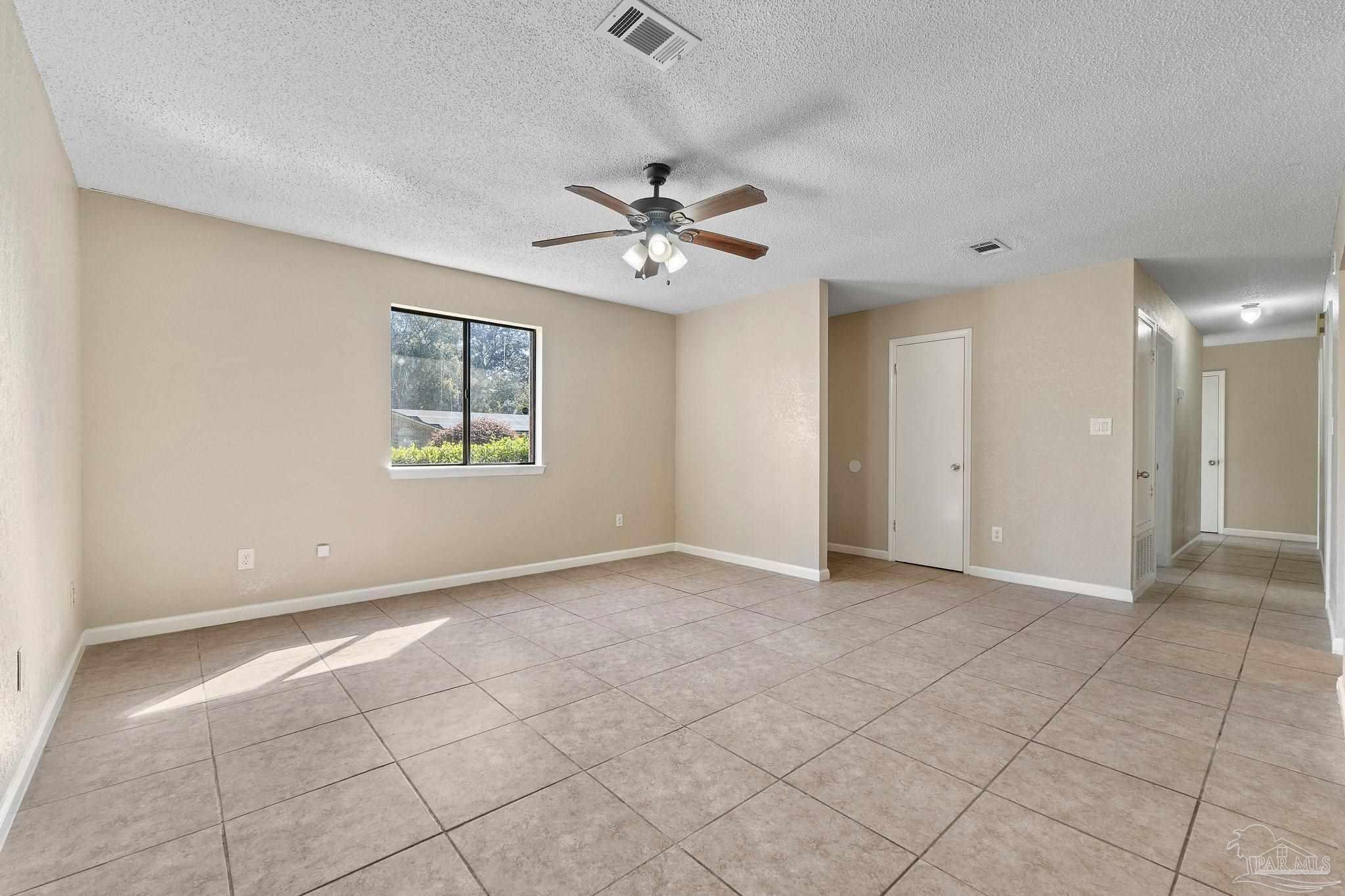 3135 Bent Oak Road Pensacola, FL 32526 - Photo 14 of 47 an empty room with chandelier fan and windows