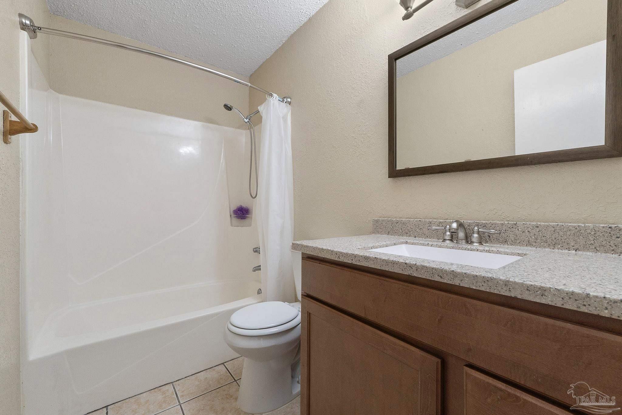 3135 Bent Oak Road Pensacola, FL 32526 - Photo 20 of 47 a bathroom with a granite countertop sink toilet a large mirror and shower