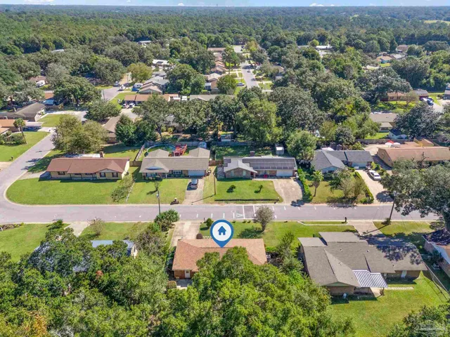 an aerial view of residential houses with outdoor space and street view