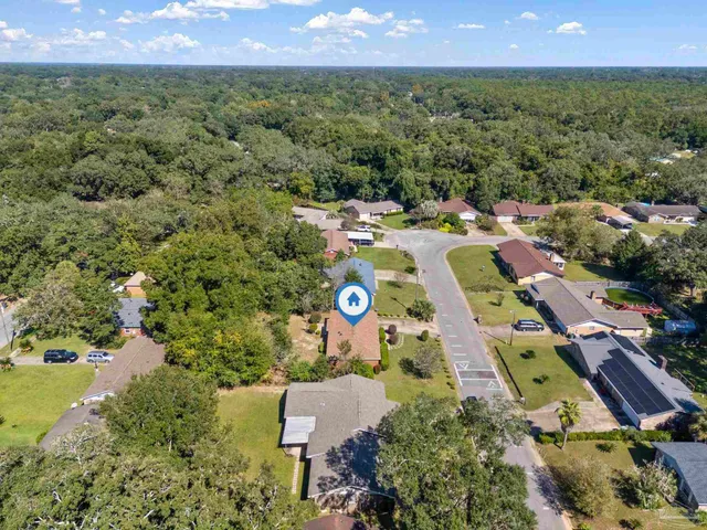 an aerial view of multiple houses with a yard