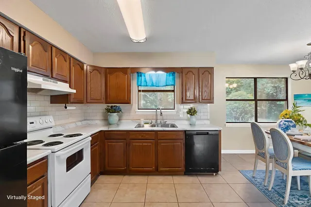 a kitchen with a stove sink and cabinets