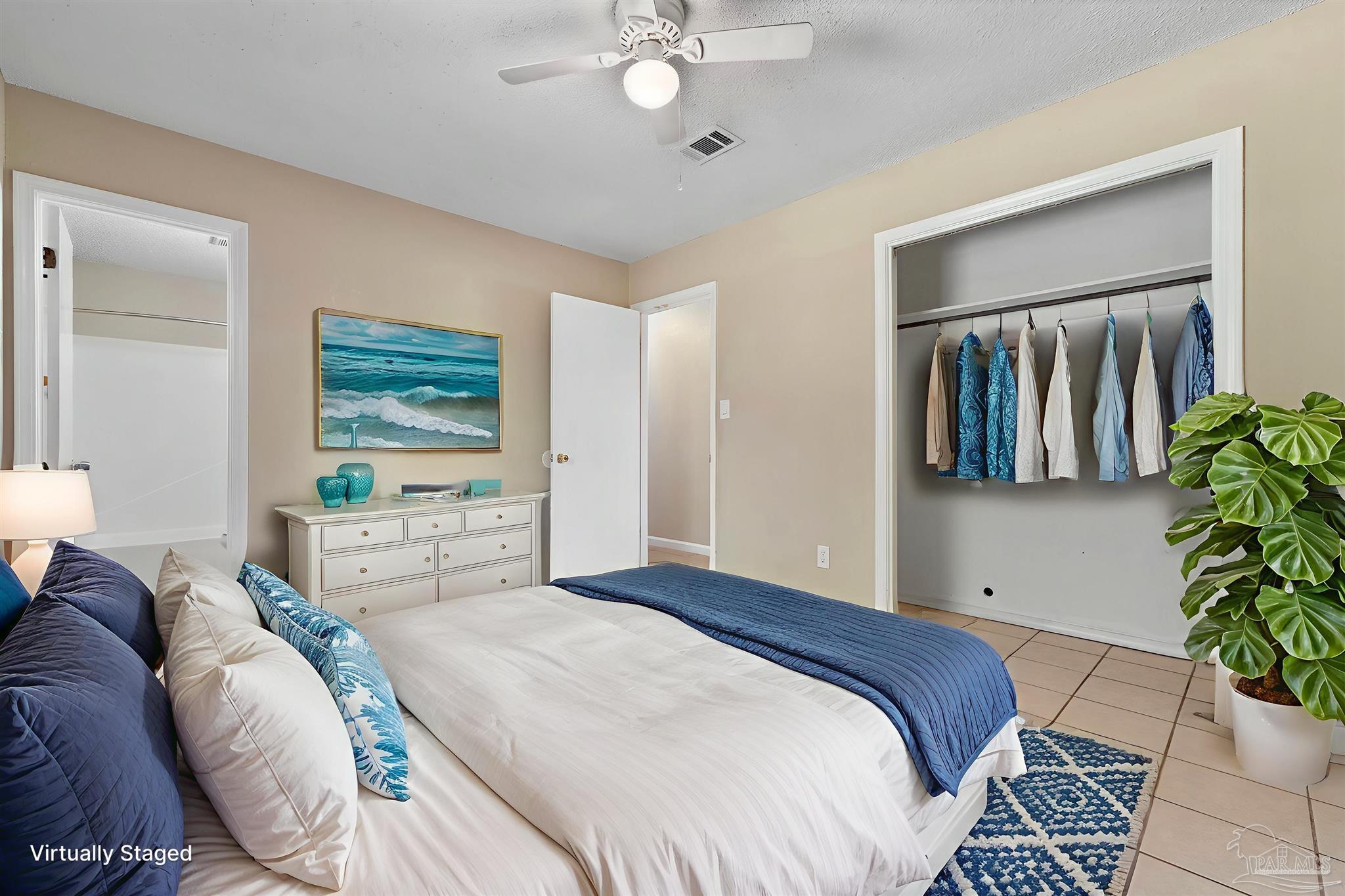 3135 Bent Oak Road Pensacola, FL 32526 - Photo 6 of 47 a bedroom with a large bed and a potted plant