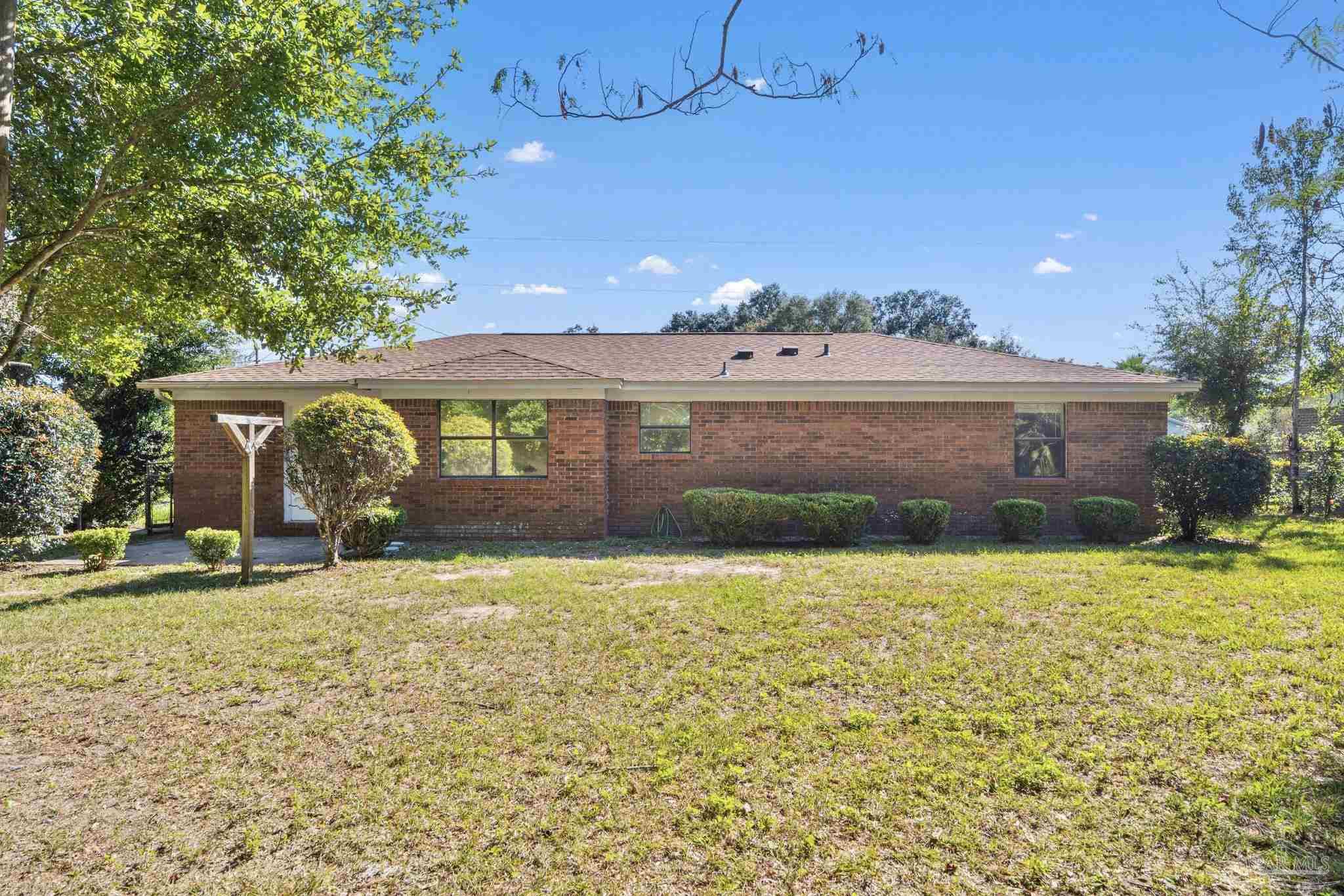 3135 Bent Oak Road Pensacola, FL 32526 - Photo 7 of 47 a front view of a house with a yard