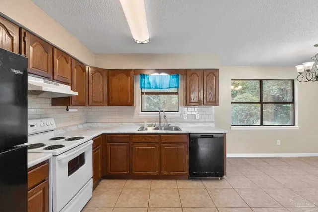 a kitchen with a sink stove and cabinets