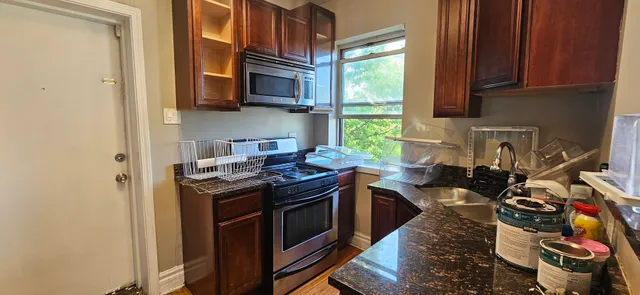 a kitchen with stainless steel appliances granite countertop a stove and a sink