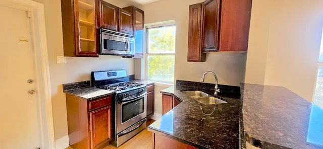 a kitchen with stainless steel appliances granite countertop a stove and a sink
