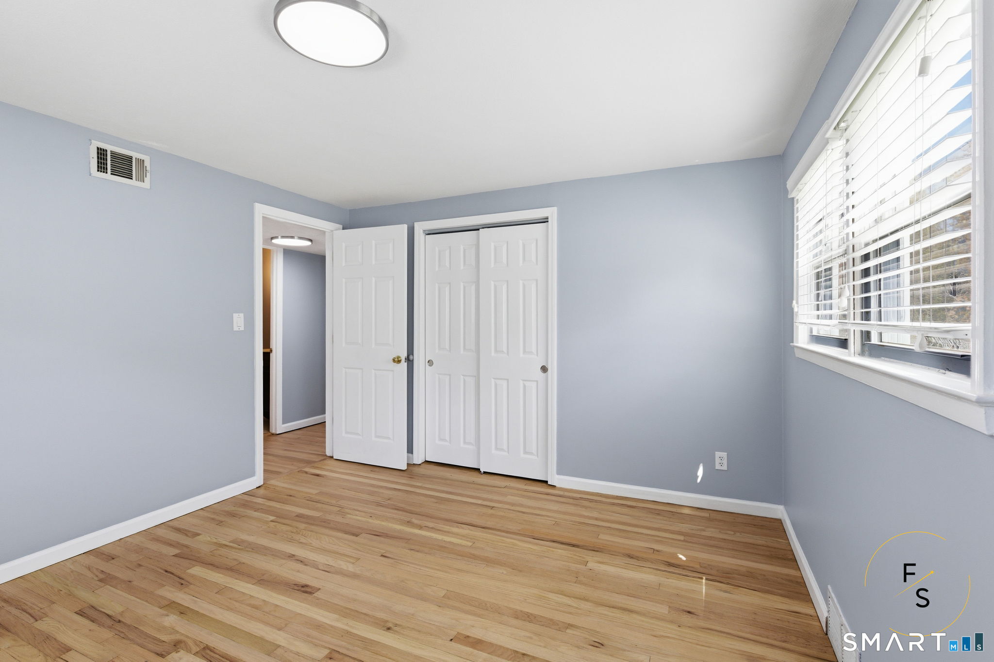 57 Concord Circle Wethersfield, CT 06109 - Photo 17 of 37 a view of empty room with wooden floor and fan